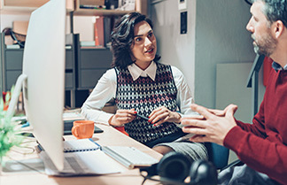 Designers talking in the office Two people discussing business in the office